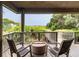 Relaxing covered balcony with comfortable seating and picturesque views of the ocean and surrounding greenery at 3560 Shipwatch Rd, Kiawah Island, SC 29455