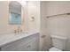 Bathroom with marble countertops, gray vanity with gold fixtures, and a blue-tiled shower at 3560 Shipwatch Rd, Kiawah Island, SC 29455