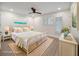 This staged bedroom features a bed with white wicker frame and a lovely ocean view at 3560 Shipwatch Rd, Kiawah Island, SC 29455