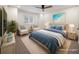 Beautifully staged bedroom featuring a wicker bed, blue linens, shuttered windows and lovely furnishings at 3560 Shipwatch Rd, Kiawah Island, SC 29455