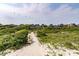 Beautifully located homes accessible via a wooden boardwalk amidst lush greenery and sandy dunes at 3560 Shipwatch Rd, Kiawah Island, SC 29455