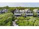 Beautiful home with balconies, surrounded by trees and lush greenery, reached by a winding wooden boardwalk at 3560 Shipwatch Rd, Kiawah Island, SC 29455