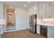 Kitchen area boasts modern stainless steel appliances and white cabinets with gold hardware at 3560 Shipwatch Rd, Kiawah Island, SC 29455