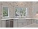 Bright kitchen features a farmhouse sink, updated stainless appliances, and designer tile backsplash at 3560 Shipwatch Rd, Kiawah Island, SC 29455