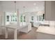 Bright, renovated kitchen featuring white cabinetry, marble countertops, and stainless steel appliances at 3560 Shipwatch Rd, Kiawah Island, SC 29455