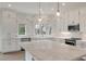 Updated kitchen with white cabinetry, marble countertop island, and stainless steel appliances at 3560 Shipwatch Rd, Kiawah Island, SC 29455