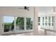 Bright living room showcasing sliding glass doors to a balcony, next to an open dining and kitchen area at 3560 Shipwatch Rd, Kiawah Island, SC 29455