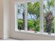 Bedroom window view showcasing lush greenery and the ocean beyond the manicured landscape at 3560 Shipwatch Rd, Kiawah Island, SC 29455
