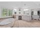 Bathroom with a large window, soaking tub and double sink vanity area at 3685 Colonel Vanderhorst Cir, Mount Pleasant, SC 29466