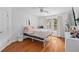 Bright bedroom with hardwood floors, a large window and minimalist decor provides a calming atmosphere at 3685 Colonel Vanderhorst Cir, Mount Pleasant, SC 29466
