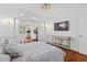Bright bedroom with a comfortable bed and an adjacent workout room and wall-mounted TV at 3685 Colonel Vanderhorst Cir, Mount Pleasant, SC 29466