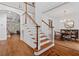 Bright foyer with hardwood floors, staircase with wood banister, and view into dining room at 3685 Colonel Vanderhorst Cir, Mount Pleasant, SC 29466