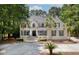 Elegant two-story home with a manicured lawn, black shutters, and a circular driveway at 3685 Colonel Vanderhorst Cir, Mount Pleasant, SC 29466