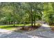 View of a long driveway leading up to a residence surrounded by mature trees and a well-maintained lawn at 3685 Colonel Vanderhorst Cir, Mount Pleasant, SC 29466