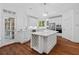 Open-concept kitchen with white cabinets, wine rack, and stainless steel appliances at 3685 Colonel Vanderhorst Cir, Mount Pleasant, SC 29466
