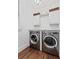A charming laundry room with front loading washer and dryer and white cabinets at 3685 Colonel Vanderhorst Cir, Mount Pleasant, SC 29466