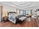 A spacious main bedroom featuring hardwood floors and a decorative tray ceiling at 3685 Colonel Vanderhorst Cir, Mount Pleasant, SC 29466