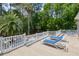 Spacious outdoor patio featuring lounge chairs, white railings, and mature landscaping at 3685 Colonel Vanderhorst Cir, Mount Pleasant, SC 29466