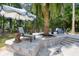 Beautiful pool patio featuring stone pavers, a lounge chair, and shaded seating area at 3685 Colonel Vanderhorst Cir, Mount Pleasant, SC 29466