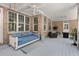 Relaxing screened porch with cushioned swing and tranquil ambiance at 3685 Colonel Vanderhorst Cir, Mount Pleasant, SC 29466
