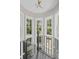Bright stairway landing with views of the surrounding trees through large, white-framed windows at 3685 Colonel Vanderhorst Cir, Mount Pleasant, SC 29466