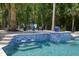 Luxury swimming pool featuring water features, in-pool bar stools, and lounge area at 3685 Colonel Vanderhorst Cir, Mount Pleasant, SC 29466