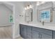 Bathroom with double sinks, quartz countertop, and stylish bronze fixtures at 395 Wappoo Trace Ln, Summerville, SC 29486