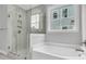 Elegant bathroom featuring a glass-enclosed shower and a soaking tub at 395 Wappoo Trace Ln, Summerville, SC 29486