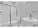 Well-lit bathroom featuring a walk-in shower with glass doors, modern sink, and white toilet at 395 Wappoo Trace Ln, Summerville, SC 29486