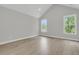 Bright bedroom with hardwood floors, vaulted ceiling, and two large windows at 395 Wappoo Trace Ln, Summerville, SC 29486
