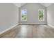 Bright bedroom with hardwood floors, vaulted ceiling, and two large windows at 395 Wappoo Trace Ln, Summerville, SC 29486