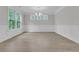 Spacious dining room with elegant wainscoting, chandelier, and natural light from multiple windows at 395 Wappoo Trace Ln, Summerville, SC 29486