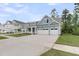 Charming light blue two-story home with a two-car garage, front porch and manicured lawn at 395 Wappoo Trace Ln, Summerville, SC 29486