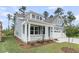 Charming, light blue two-story home with manicured lawn and covered front porch at 395 Wappoo Trace Ln, Summerville, SC 29486