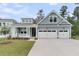 Charming, light blue two-story home featuring a two-car garage, front porch and manicured lawn at 395 Wappoo Trace Ln, Summerville, SC 29486
