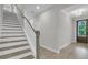 Bright foyer with stairs, wood-look floors and stylish glass-paneled front door at 395 Wappoo Trace Ln, Summerville, SC 29486