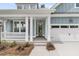 Inviting entryway with an elegant glass front door and two-car garage at 395 Wappoo Trace Ln, Summerville, SC 29486