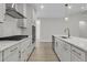 Close up of modern kitchen with white cabinets, stainless steel appliances, and stone countertops at 395 Wappoo Trace Ln, Summerville, SC 29486