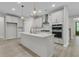 Modern kitchen with white cabinets, stainless steel appliances, and a center island with pendant lights at 395 Wappoo Trace Ln, Summerville, SC 29486