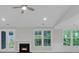 Bright living room features a fireplace, a ceiling fan, and backyard views at 395 Wappoo Trace Ln, Summerville, SC 29486