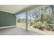 Inviting screened-in porch showcasing an outdoor living space with views of the green backyard at 395 Wappoo Trace Ln, Summerville, SC 29486