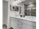 Bathroom featuring double sinks with white cabinets, modern faucets, and a tiled shower at 432 Caledon Ct, Johns Island, SC 29455
