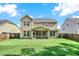 Expansive backyard with lush green lawn and a view of the home's screened porch at 466 Gianna Ln, Goose Creek, SC 29445