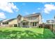 Spacious, fenced backyard featuring a lush lawn and view of the screened-in porch at 466 Gianna Ln, Goose Creek, SC 29445