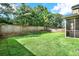 View of the backyard with privacy fence and a glimpse of the screened-in porch at 466 Gianna Ln, Goose Creek, SC 29445