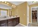 Bathroom with double sinks, vanity with dark cabinets, and walk-in closet at 466 Gianna Ln, Goose Creek, SC 29445