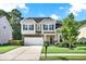 Charming two-story home featuring a stone facade, attached garage, and manicured lawn at 466 Gianna Ln, Goose Creek, SC 29445