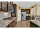 Spacious kitchen featuring stainless appliances, granite counters, and dark wood cabinets at 466 Gianna Ln, Goose Creek, SC 29445