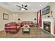 Inviting living room featuring a fireplace, comfortable seating, and a ceiling fan at 466 Gianna Ln, Goose Creek, SC 29445
