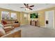 Spacious living room with yellow walls, ceiling fan, and comfortable leather couches at 466 Gianna Ln, Goose Creek, SC 29445